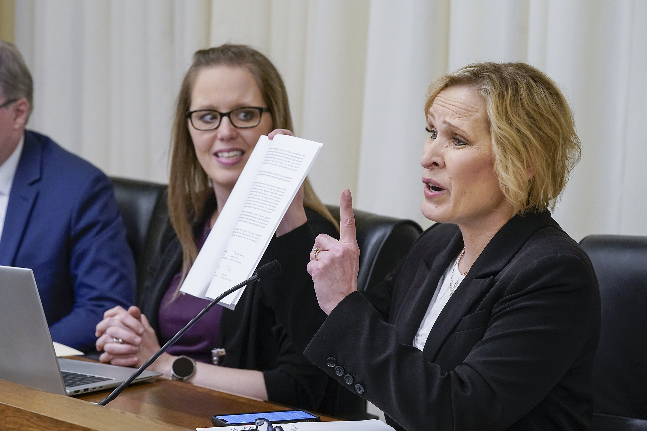 Sara Paul, superintendent for North Branch Area Public Schools, expresses support for HF1538 with the House Education Finance Committee March 13. The teacher apprenticeship funding bill is sponsored by Rep. Patricia Mueller, left. (Photo by Michele Jokinen)